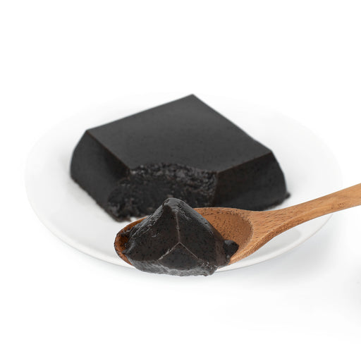 A spoon of black sesame tofu
