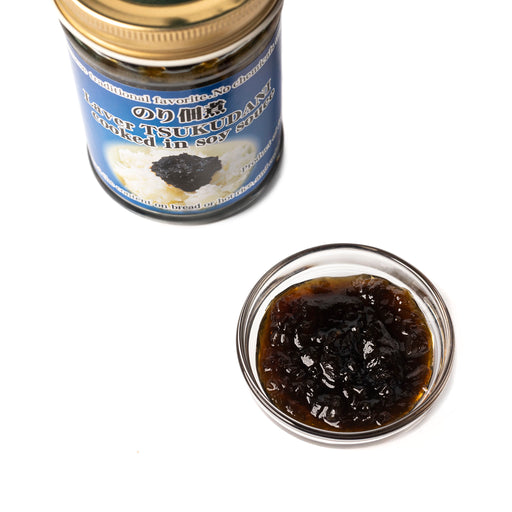 A small bowl of nori seaweed paste next to bottle of the product
