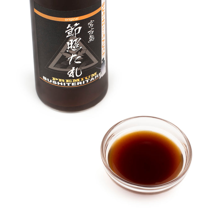 A bowl of Okinawa teriyaki sauce next to a package bottle of the product