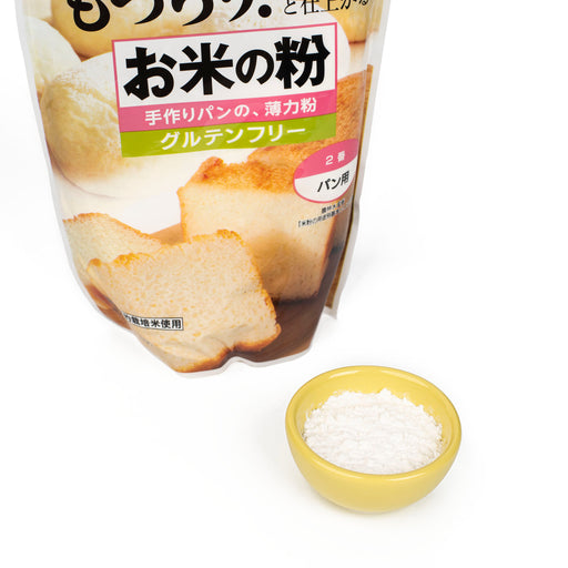 A bowl of rice flour in front of a package of the product
