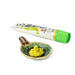 A small bowl of coarsely grated hon wasabi next to bottle of the product