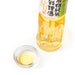 A small bowl of organic cooking sake next to bottle of the product - diagonal angle