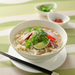 A bowl of kishimen noodles with Vietnamese style soup