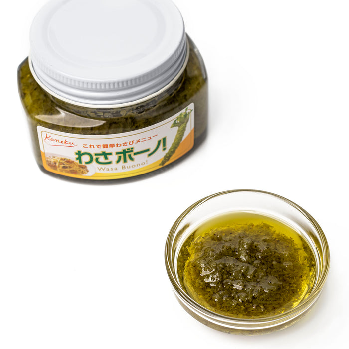 A small bowl of wasabi pesto sauce next to bottle of the product
