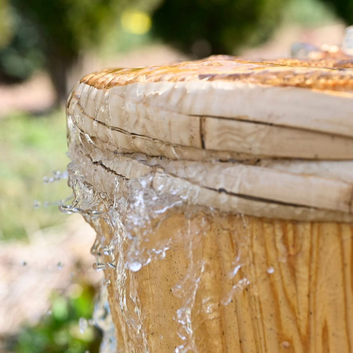Spring water gushing out through wooden barrel