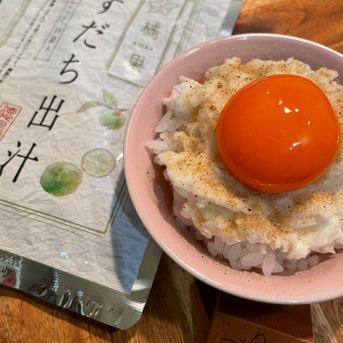A bowl of steamed rice topped with egg yolk