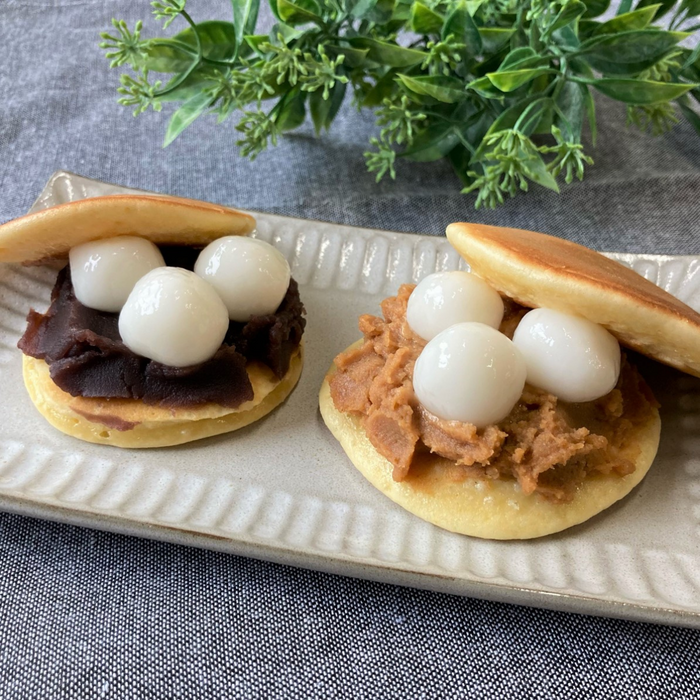 A plate of two pancake sandwiches stuffed with anko and mochi