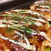 Okonomiyaki pancakes on grilling pan