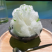 A bowl of shaved ice topped with sudachi peel and syrup