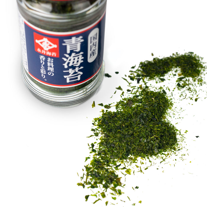 Scattered nori seaweed flakes next to a bottle of the product