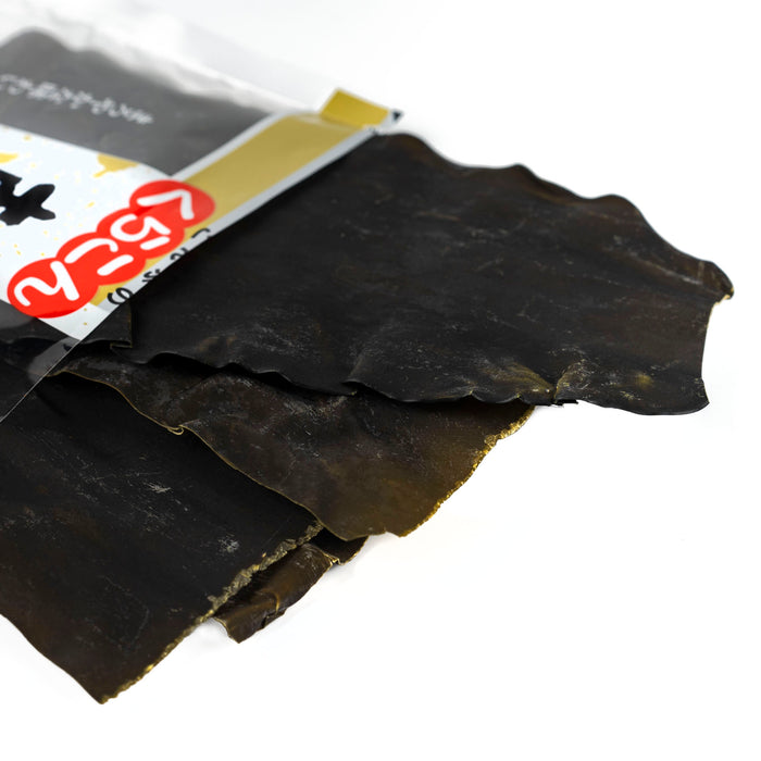 Dried kombu kelp popping out of package of the product