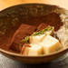 A bowl of sesame tofu topped with powdered chocolate