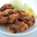 A plate of fried chicken with sliced lemon