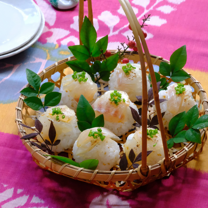 Seven rice balls topped with white fish