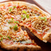 A pizza pie topped with dried natto