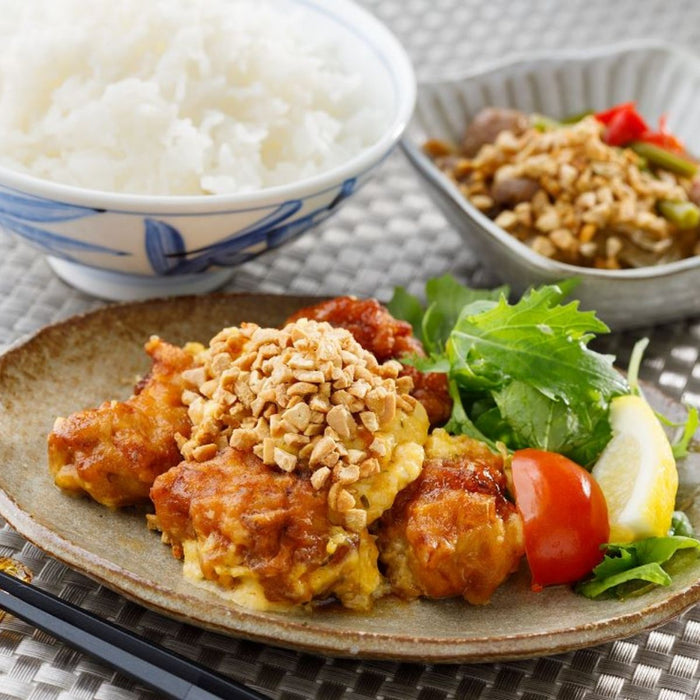 A plate of fried chicken topped with dried natto
