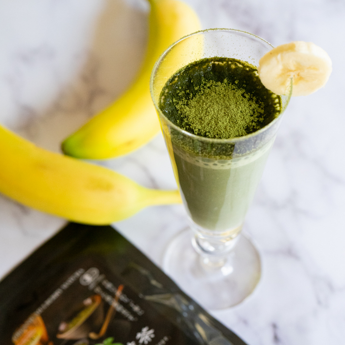 A glass of mulberry matcha smoothie
