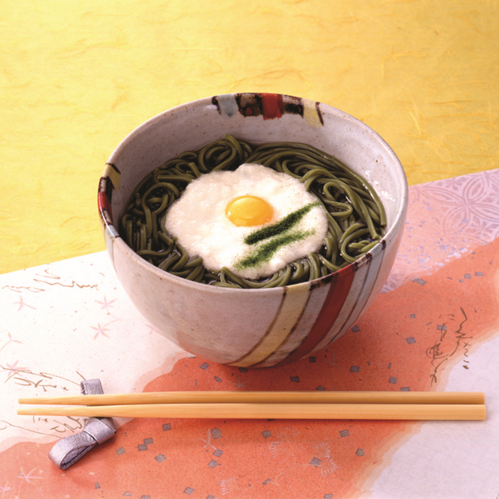 A bowl of cha soba noodles soup topped with egg