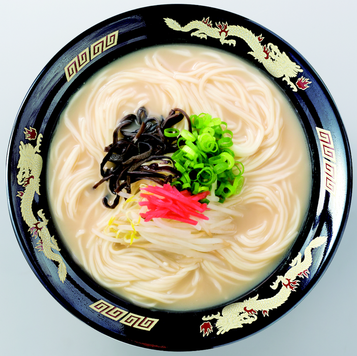 A bowl of tonkotsu ramen noodles with pickled ginger, bamboo shoot and scallion