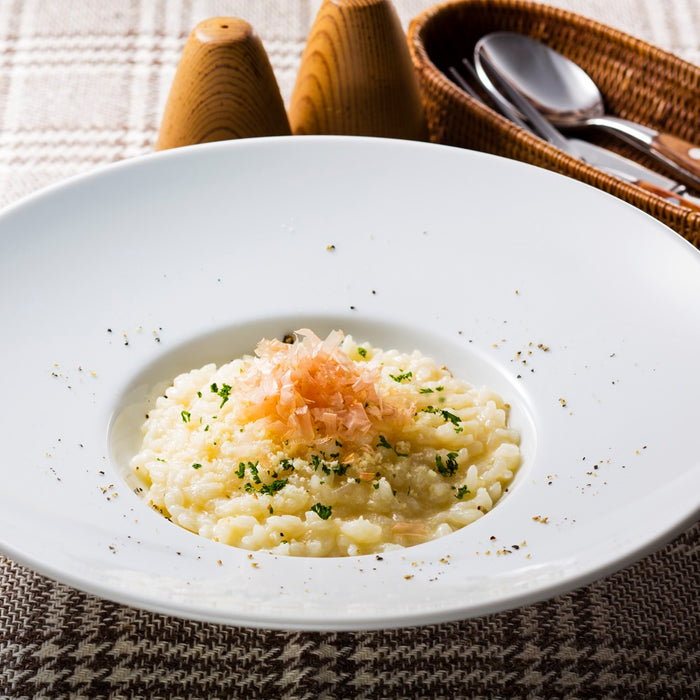 A plate of risotto topped with dried bonito flakes