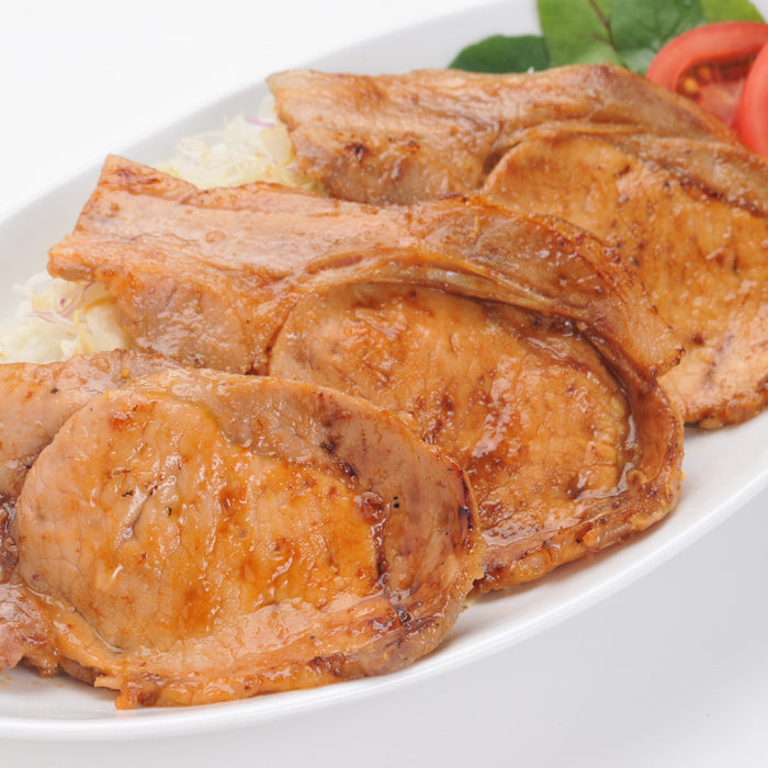 a plate of thin sliced grilled pork