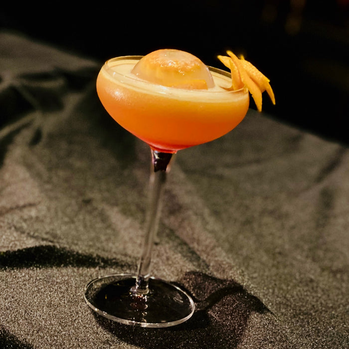 A glass of rose syrup blended cocktail 