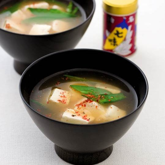 Two bowls of miso soup topped with shichimi tograshi pepper powder